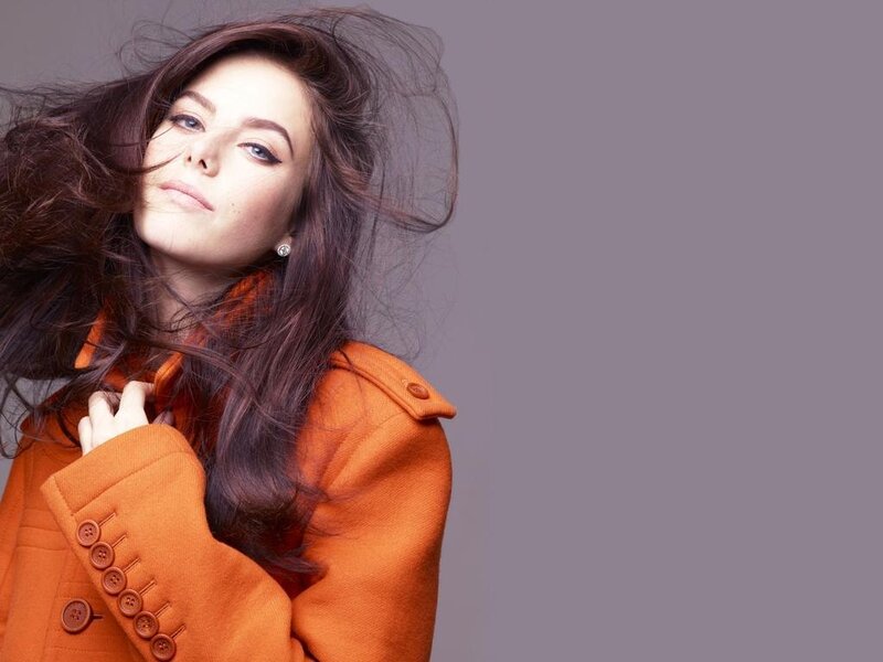 Woman in Orange Coat — Dramatic