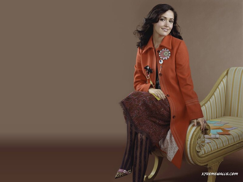 woman in orange coat sitting