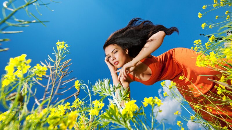 woman in orange dress among flowers