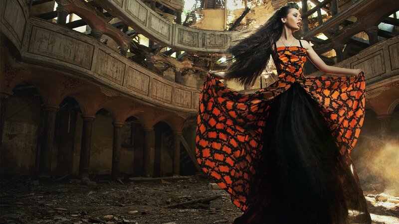 woman in orange dress in ruin
