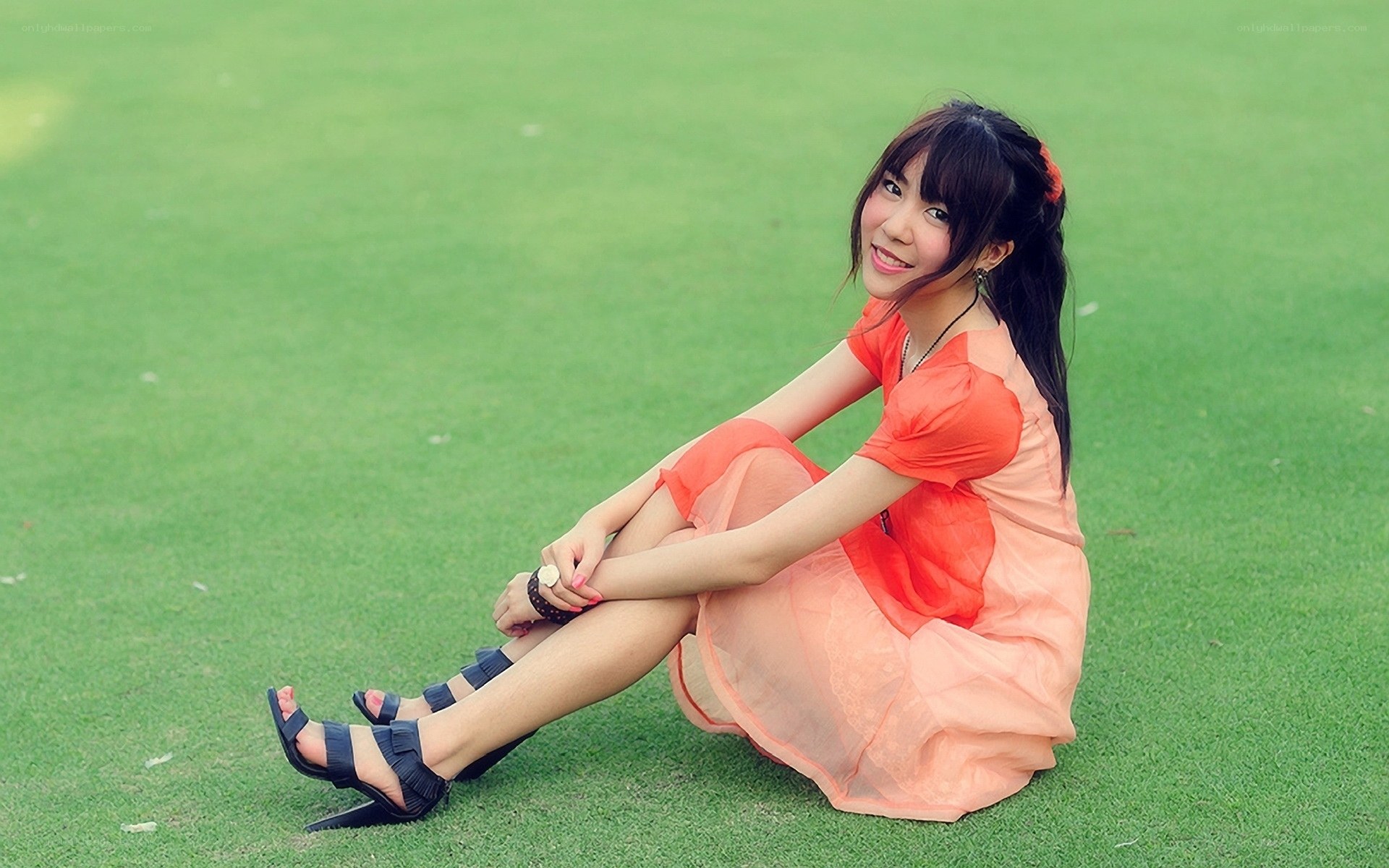 Woman in orange dress on grass
