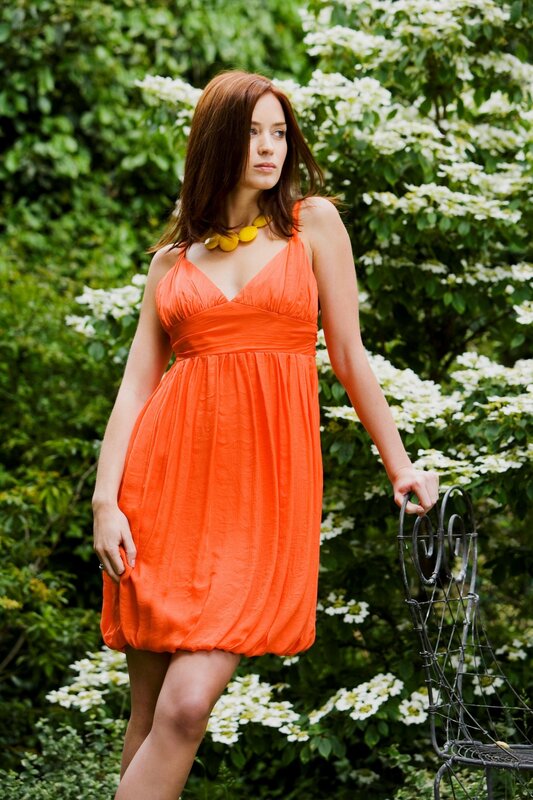 Woman in orange dress outdoors
