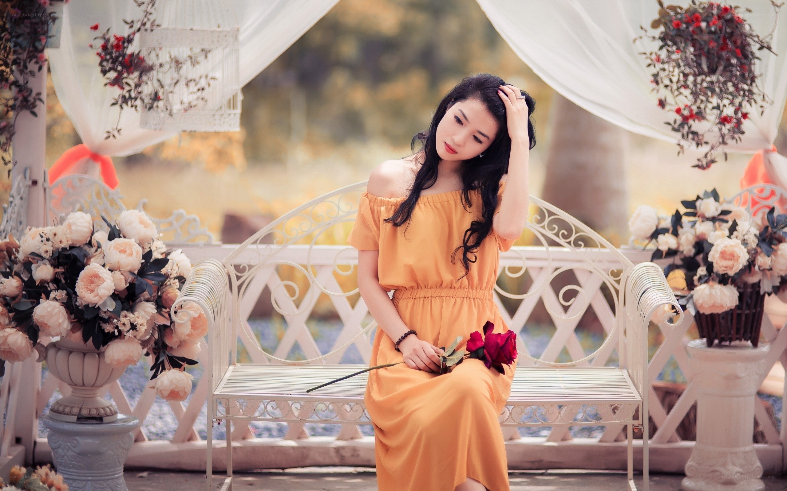 Woman in orange dress with flowers