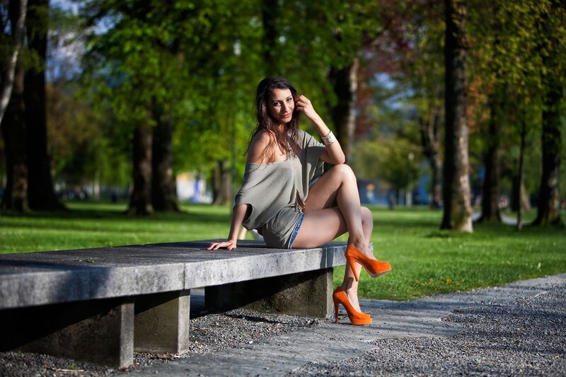 Woman in orange heels on bench