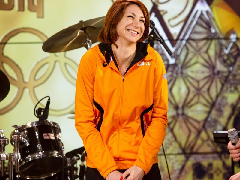 Woman in Orange Jacket — Happy