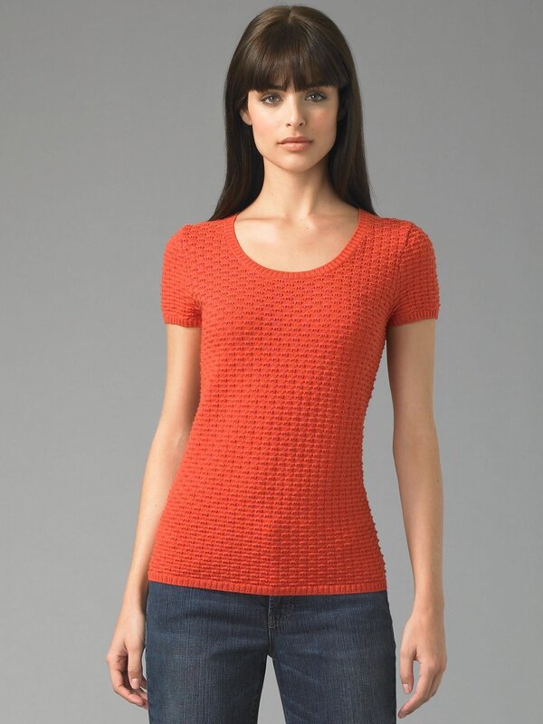 woman in orange knit top