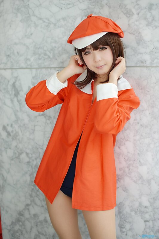 Woman in Orange Outfit — Playful, Photograph, Hat