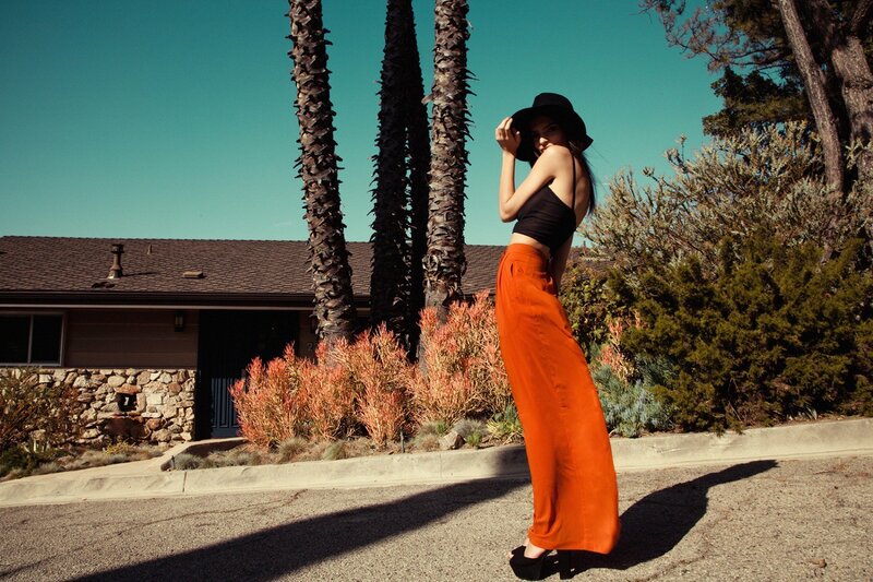 Woman in orange pants and hat