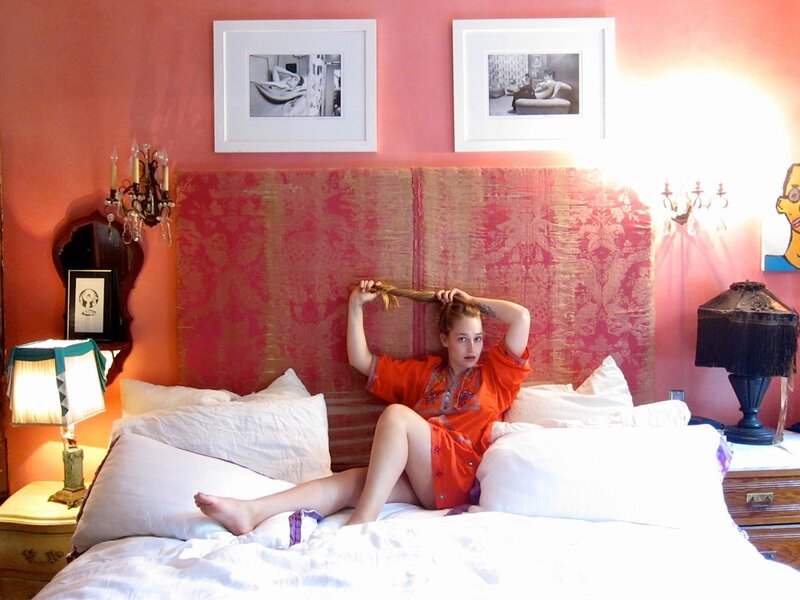 Woman in orange robe on bed