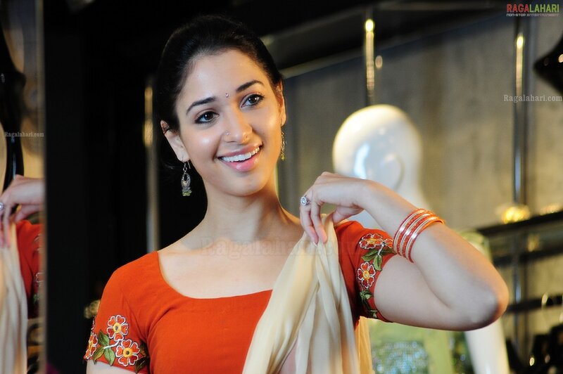 woman in orange sari smiling