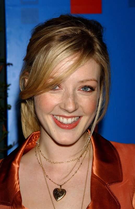 woman in orange satin smiling