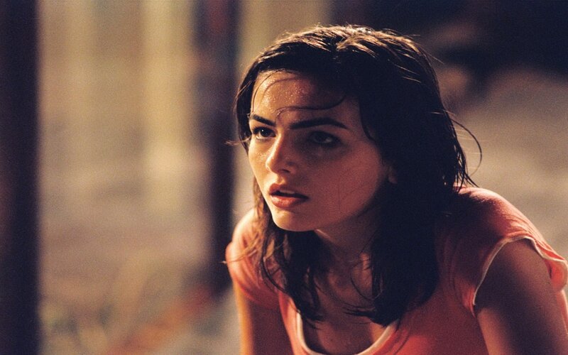 woman in orange shirt looking concerned