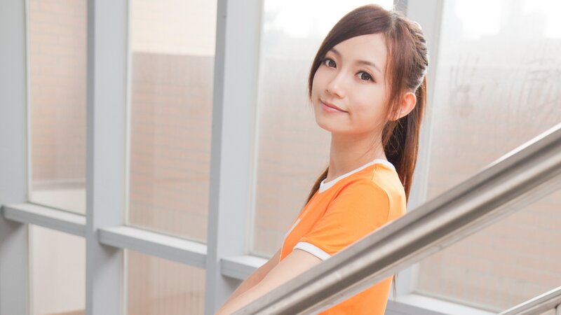 woman in orange shirt smiling