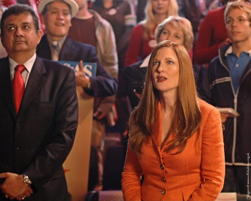 woman in orange suit at event
