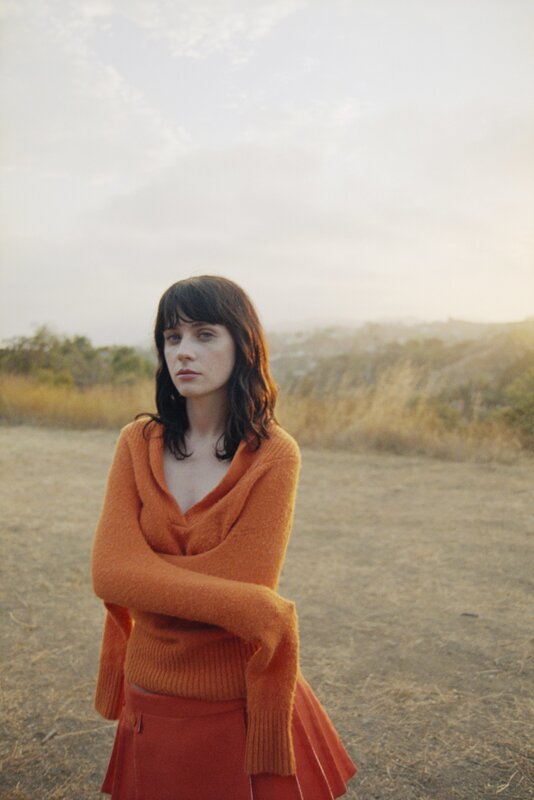 Woman in orange sweater