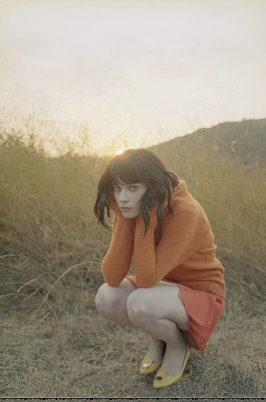 woman in orange sweater crouching