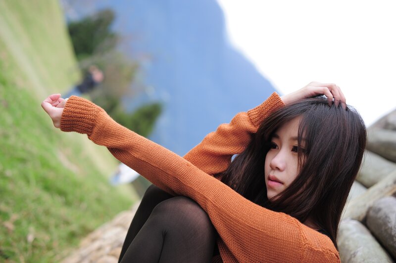 woman in orange sweater outdoors