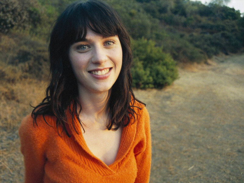 woman in orange sweater outdoors