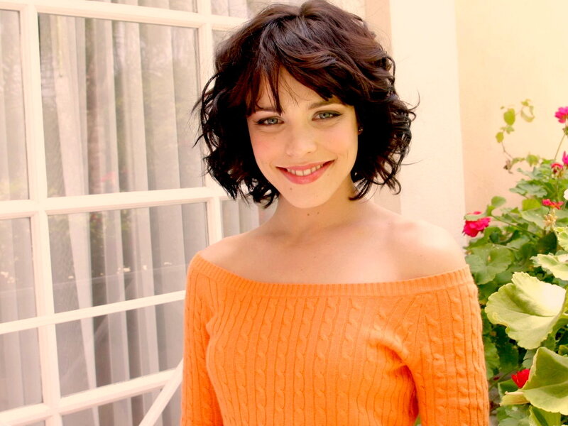 woman in orange sweater smiling