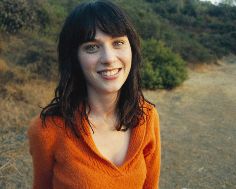 woman in orange sweater smiling