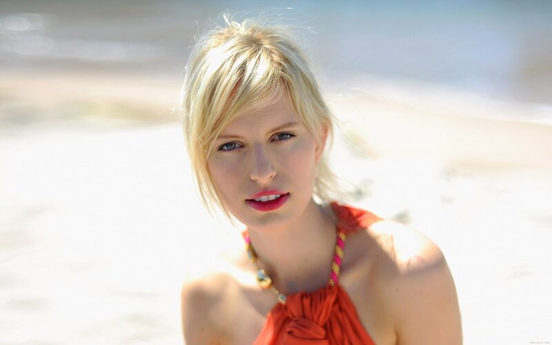 woman in orange top at beach