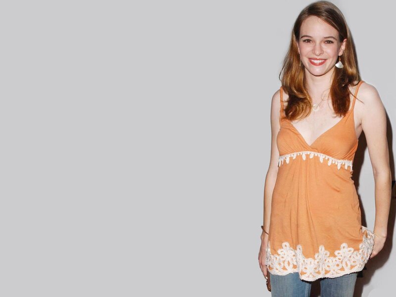 Woman in Orange Top — Neutral, Photograph, Jeans