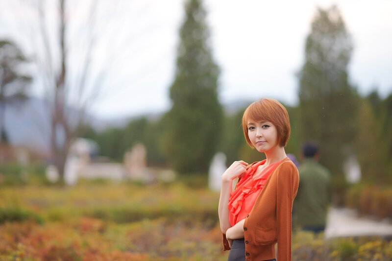 woman in orange top outdoors