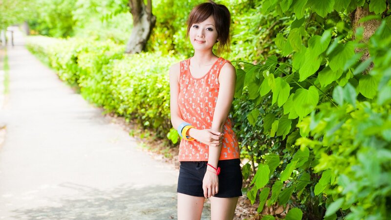 woman in orange top outdoors