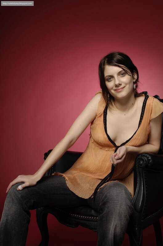 woman in orange top sitting