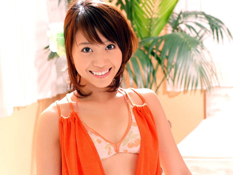 woman in orange top smiling