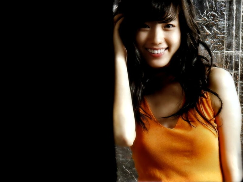 woman in orange top smiling