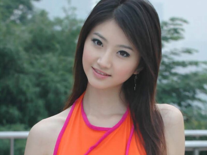 woman in orange top smiling
