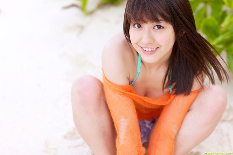 Woman in orange towel at beach
