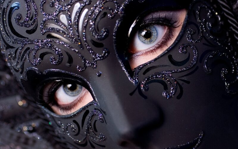 woman in ornate black mask