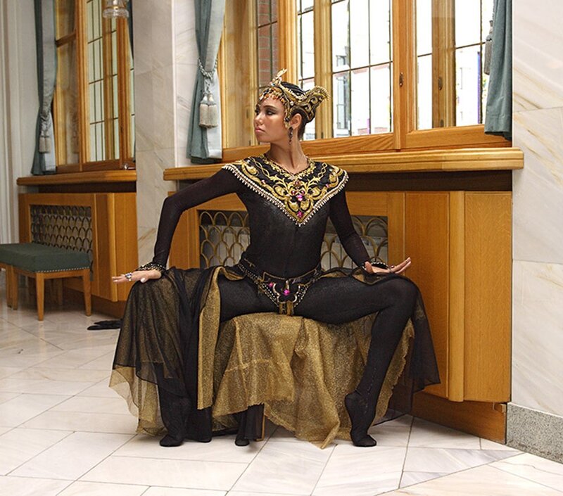 woman in ornate costume sitting