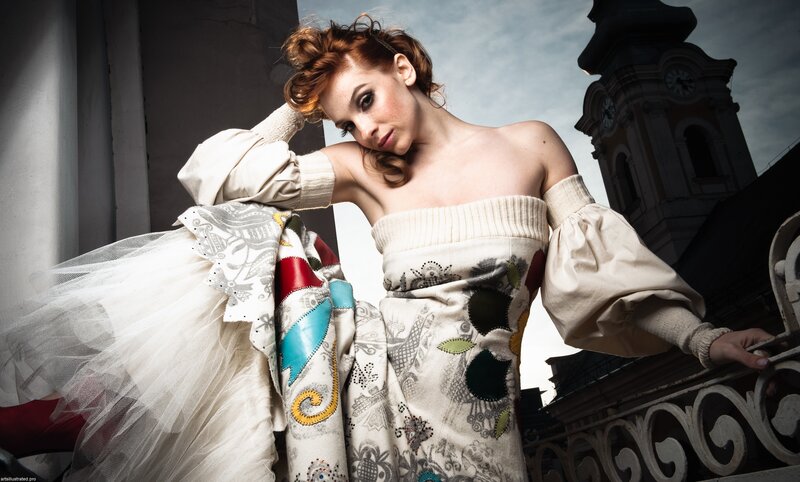 woman in ornate dress on balcony