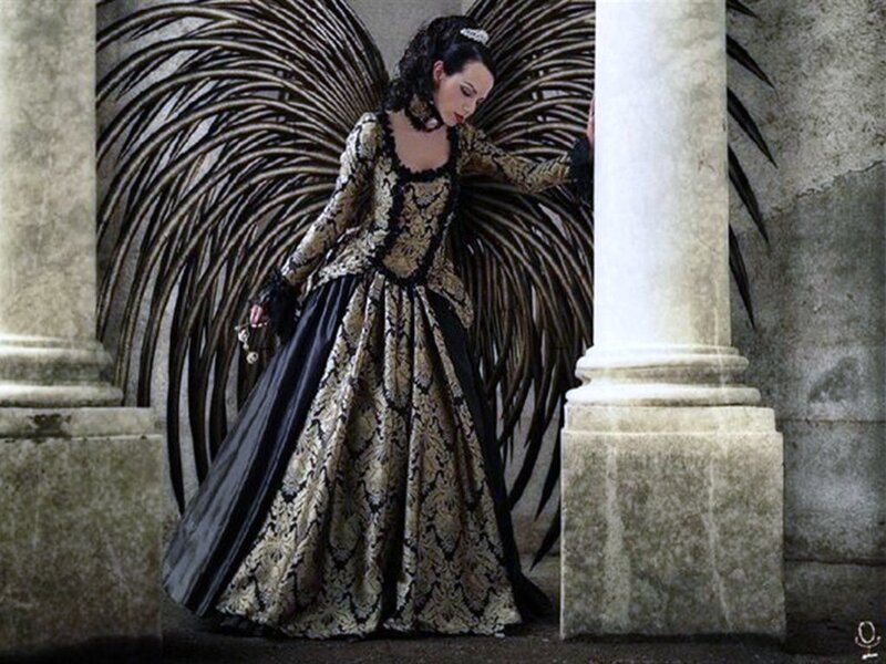 woman in ornate dress with wings