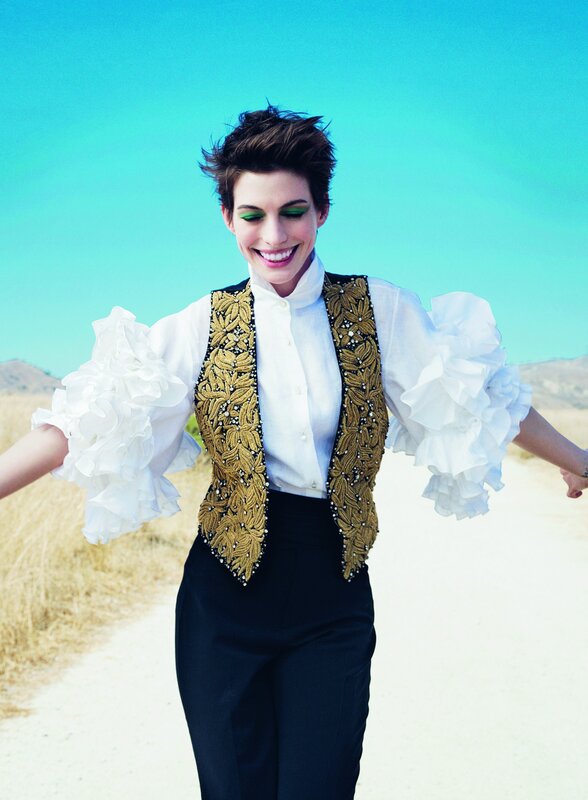 woman in ornate vest smiling