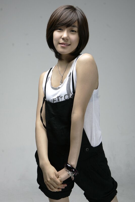 woman in overalls smiling