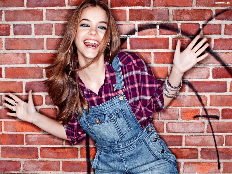 woman in overalls smiling