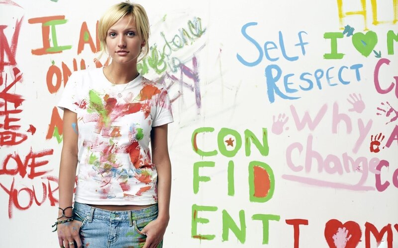 woman in paint-splattered shirt