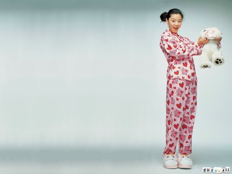 woman in pajamas holding teddy bear