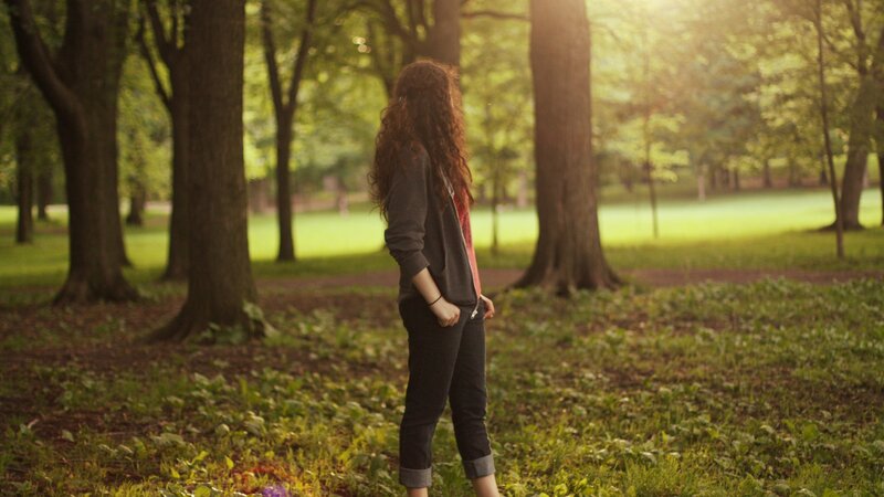 woman in park at sunset