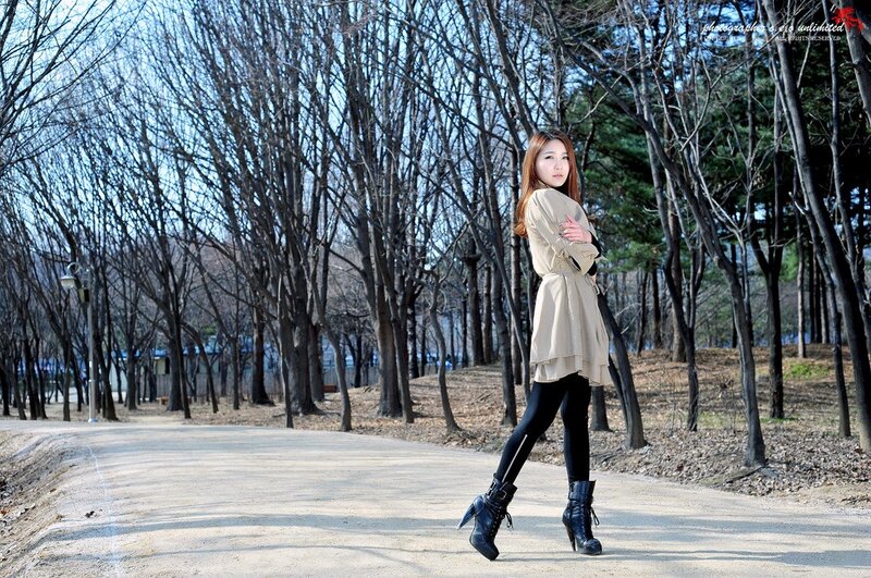 Woman in park with bare trees