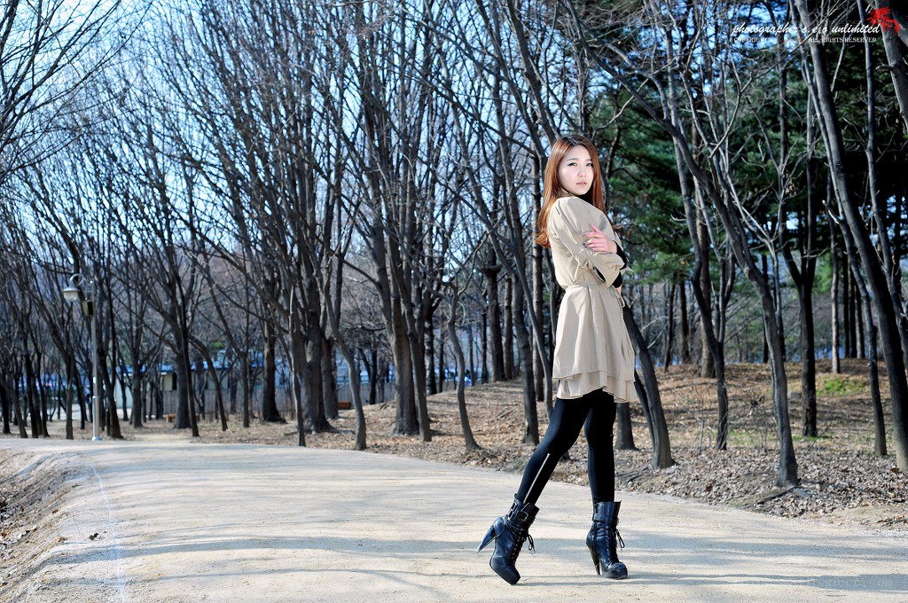 Woman in park with bare trees
