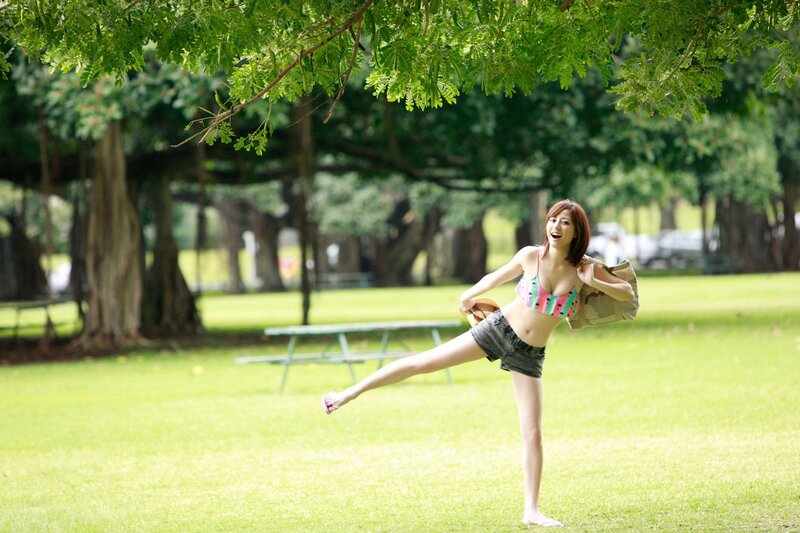 Woman in park with beach bag