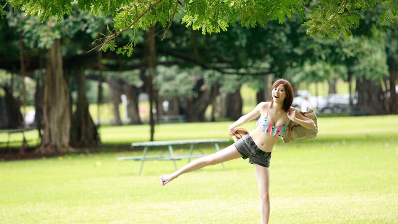 Woman in park with bikini top
