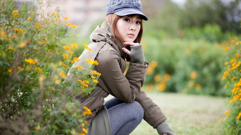 woman in park with flowers