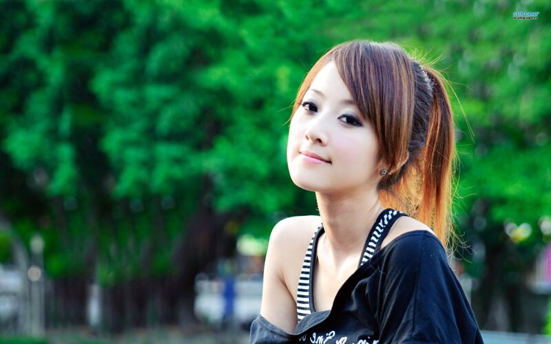 woman in park with green background
