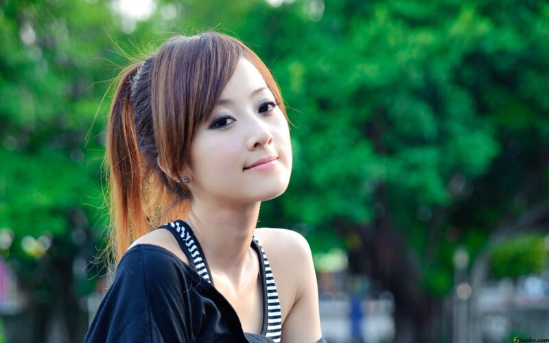 woman in park with green background